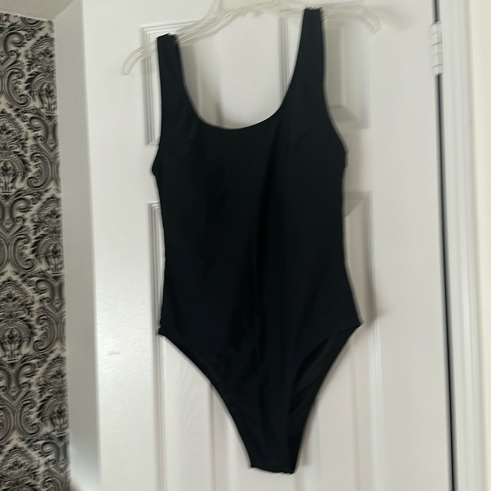 Summer may one piece black bathing suit with a high cut leg